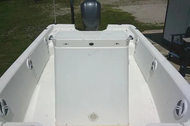 Slide: The Image of 2006 SeaChaser 250 BAYRUNNER boat interior with white seating and motor. - 10