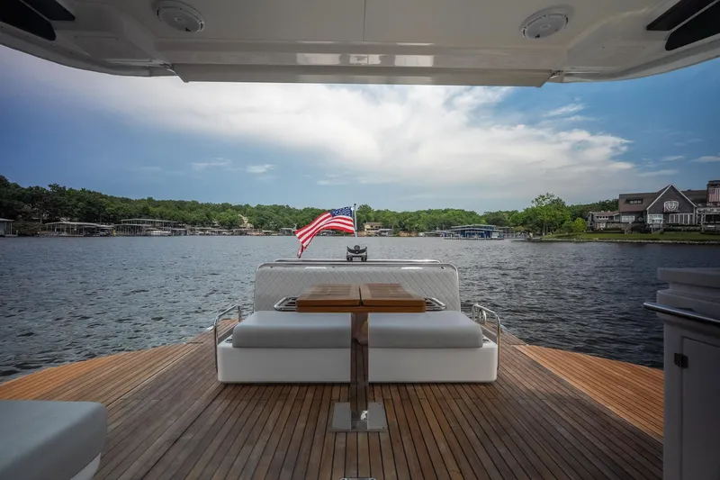 Slide: The Image of Luxurious 2024 Schaefer 375 yacht deck with scenic lake view and American flag. - 31
