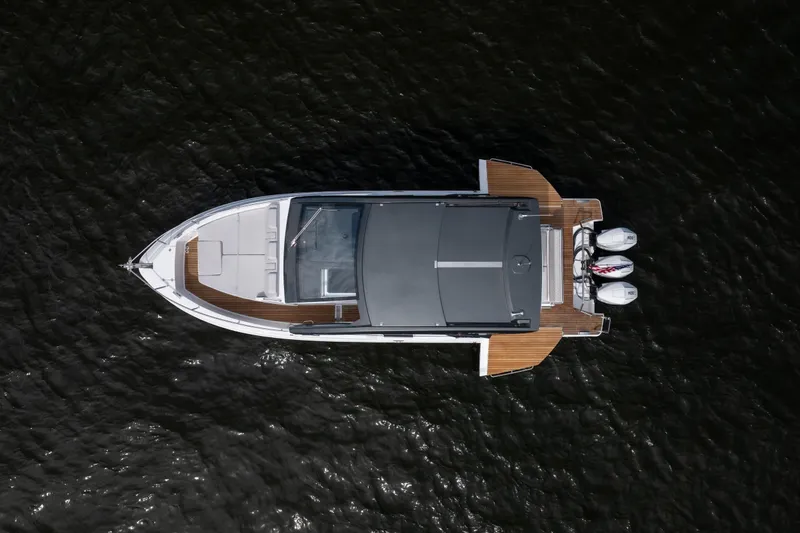 Slide: The Image of Top view of 2024 Schaefer 375 boat with triple outboard engines on water. - 3