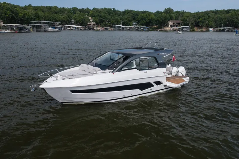Slide: The Image of 2024 Schaefer 375 yacht on a lake, surrounded by lush greenery and docks. - 2