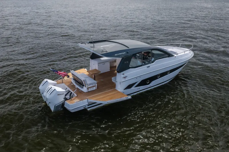 Slide: The Image of 2024 Schaefer 375 yacht on open water, featuring sleek design and twin Mercury engines. - 7