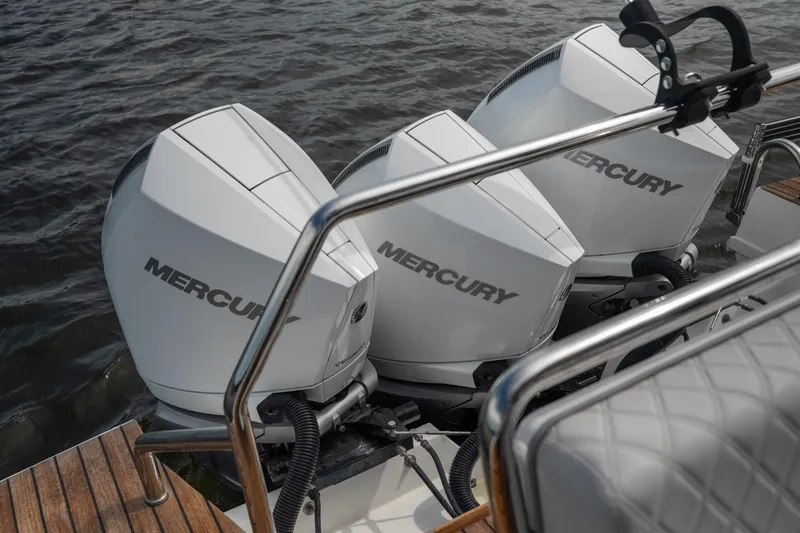 Slide: The Image of Triple Mercury outboard engines on 2024 Schaefer 375 boat, docked on water. - 26