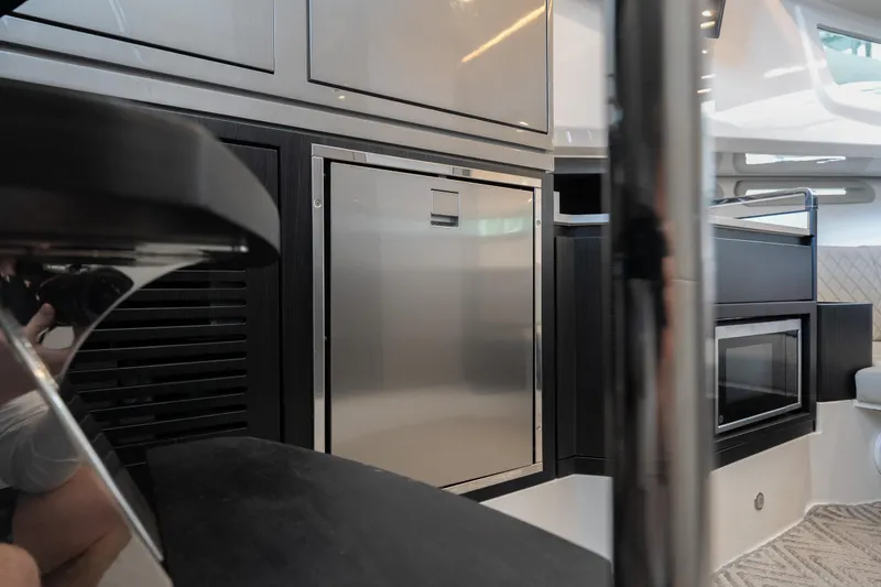 Slide: The Image of Interior of 2024 Schaefer 375 yacht featuring modern kitchen appliances and sleek design. - 34