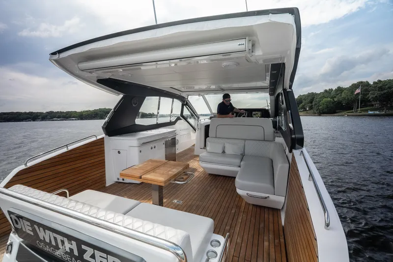 Slide: The Image of Luxurious 2024 Schaefer 375 yacht interior with elegant seating and wooden deck on a serene lake. - 27