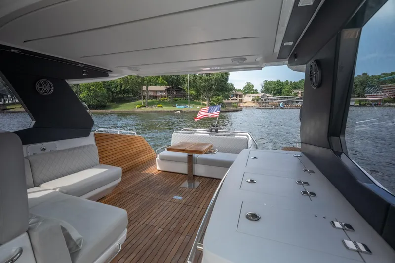 Slide: The Image of Luxurious 2024 Schaefer 375 yacht interior with elegant seating and scenic waterfront view. - 16