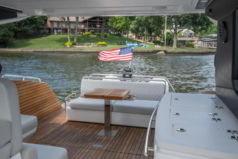 Slide: The Image of Luxury Schaefer 375 yacht interior, 2024 model, with American flag and scenic waterfront view. - 21
