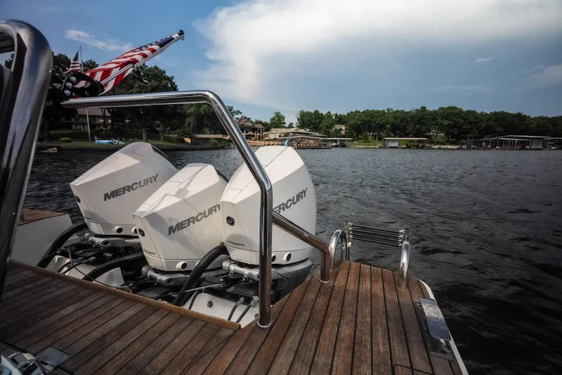 Slide: The Image of Schaefer 375 boat with dual Mercury engines on a lake, 2024 model. - 11