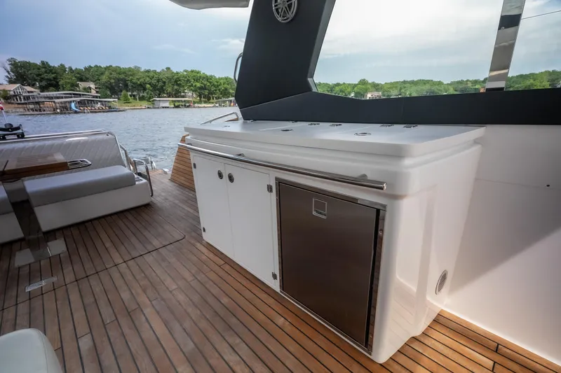 Slide: The Image of Luxury yacht deck with sleek cabinetry, Schaefer 375 model, 2024, overlooking serene lake view. - 17