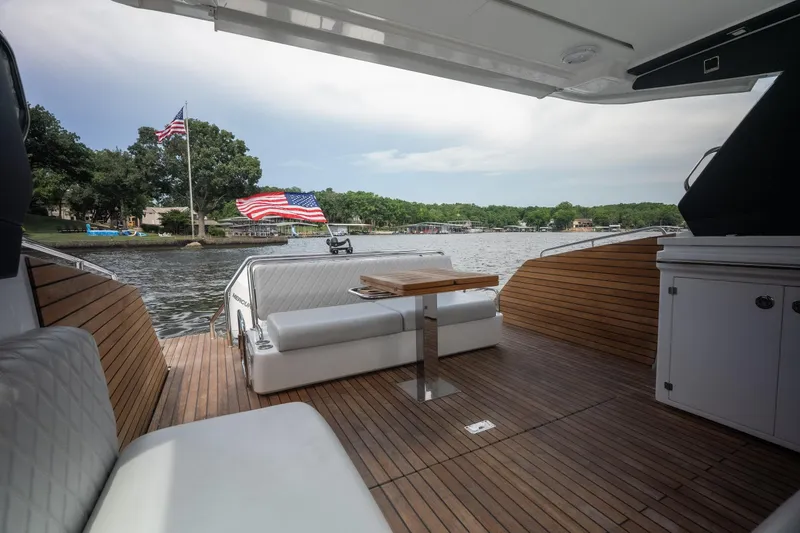Slide: The Image of Luxurious 2024 Schaefer 375 yacht interior with wooden deck and scenic lake view. - 22