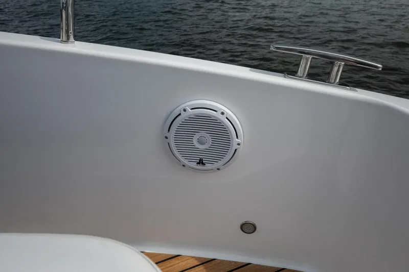 Slide: The Image of 2024 Schaefer 375 boat speaker and cleat on deck by water. - 32