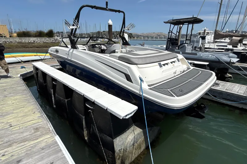 Slide: The Image of 2021 Bayliner VR5 Bowrider I/O docked at marina, showcasing sleek design and spacious deck. - 23