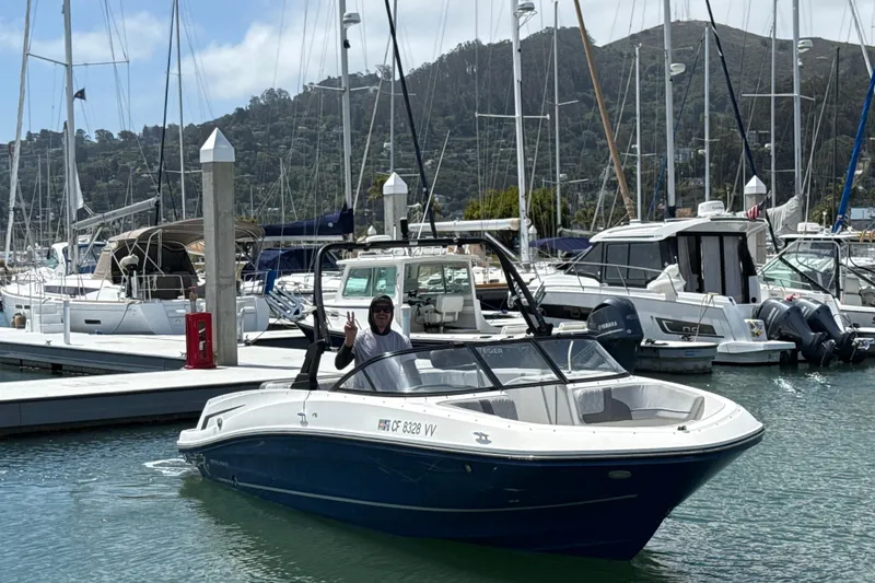 Slide: The Image of 2021 Bayliner VR5 Bowrider I/O in marina, surrounded by sailboats and yachts. - 9