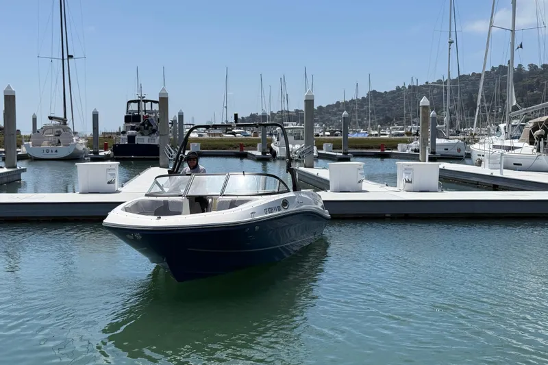 Slide: The Image of 2021 Bayliner VR5 Bowrider I/O docked at a marina with sailboats in the background. - 3