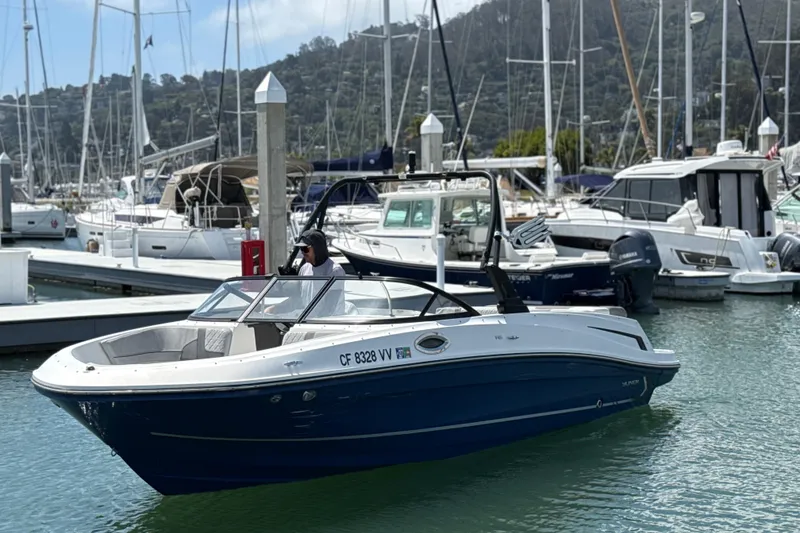 Slide: The Image of 2021 Bayliner VR5 Bowrider I/O in marina, surrounded by other boats. - 14