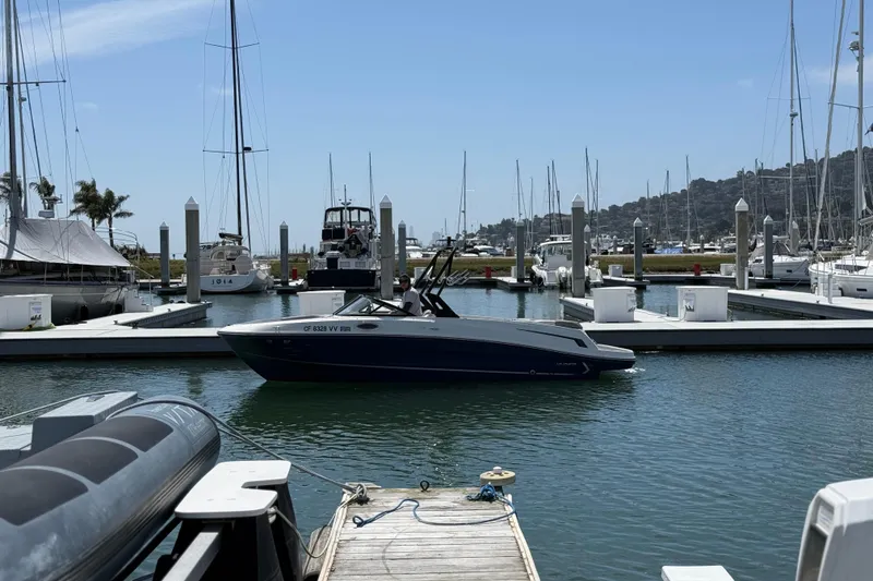 Slide: The Image of 2021 Bayliner VR5 Bowrider I/O docked at a marina with sailboats in the background. - 4