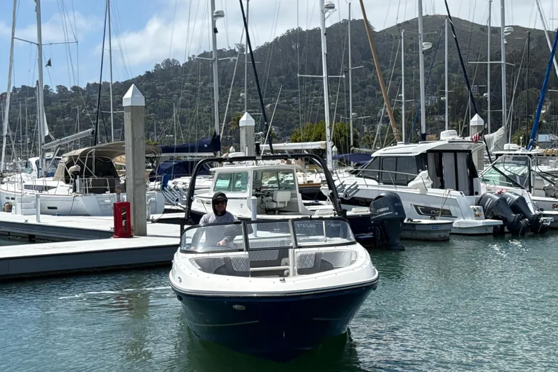 Slide: The Image of 2021 Bayliner VR5 Bowrider I/O in marina, surrounded by sailboats and yachts. - 11