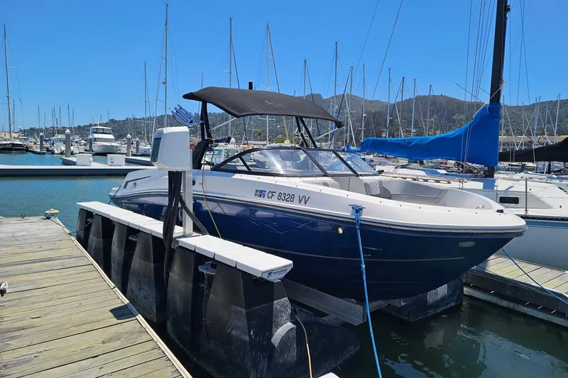 Slide: The Image of 2021 Bayliner VR6 Bowrider I/O docked at a marina with sailboats. - 15