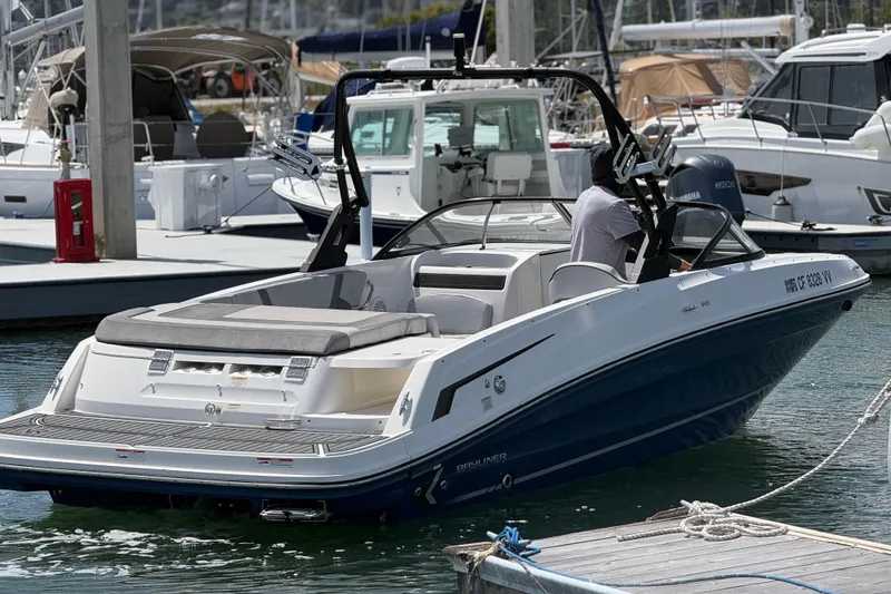 Slide: The Image of 2021 Bayliner VR5 Bowrider I/O docked at marina, featuring sleek design and spacious seating. - 7