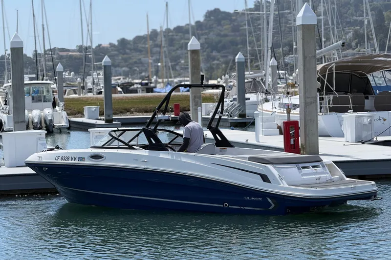 Slide: The Image of 2021 Bayliner VR5 Bowrider I/O in marina, sleek design, blue and white exterior. - 5