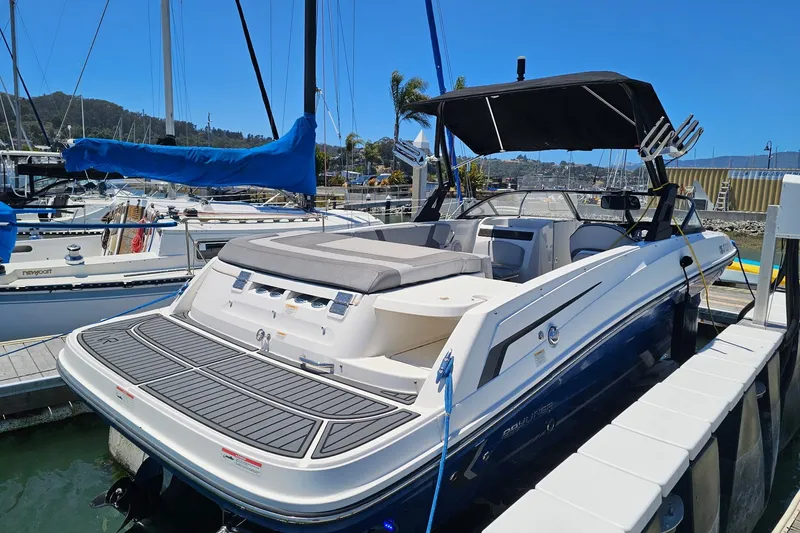Slide: The Image of 2021 Bayliner VR6 Bowrider I/O docked at marina, featuring sleek design and spacious seating. - 14