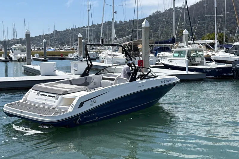 Slide: The Image of 2021 Bayliner VR5 Bowrider I/O docked at a marina with surrounding boats. - 8
