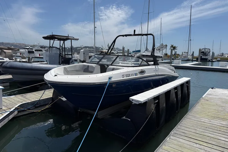 Slide: The Image of 2021 Bayliner VR5 Bowrider I/O docked at marina under clear sky. - 20