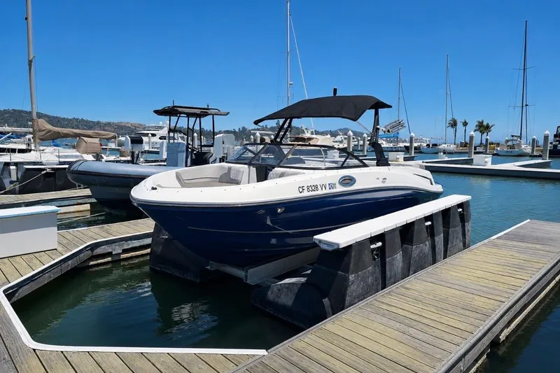 Slide: The Image of 2021 Bayliner VR6 Bowrider I/O docked at a marina under clear blue skies. - 16