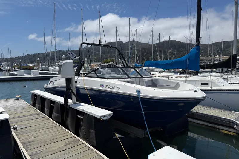Slide: The Image of 2021 Bayliner VR5 Bowrider I/O docked at a marina under a clear sky. - 21