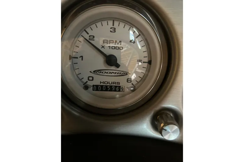 Slide: The Image of 2004 Moomba Mobius XLV tachometer showing 596 hours and RPM gauge. - 5