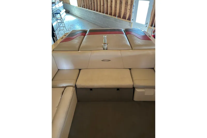 Slide: The Image of 2004 Moomba Mobius XLV boat interior with beige and red seating in a garage. - 2