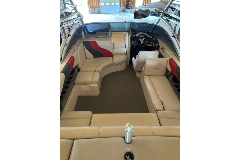 Slide: The Image of 2004 Moomba Mobius XLV boat interior with beige seating and dashboard view. - 1