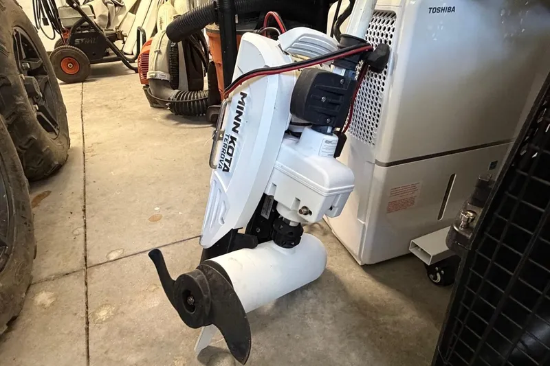 Slide: The Image of Minn Kota Terrova trolling motor in a garage, near Edgewater 230CC boat equipment. - 32