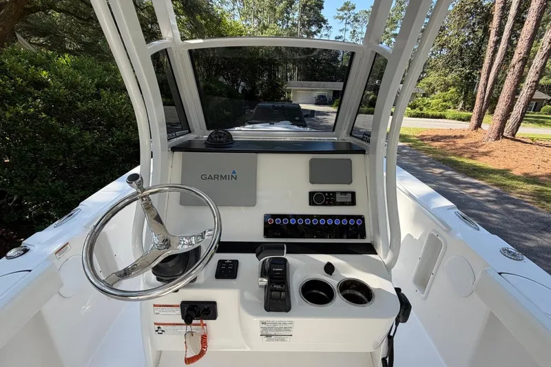 Slide: The Image of Edgewater 230CC 2019 boat console with Garmin navigation system and steering wheel. - 15