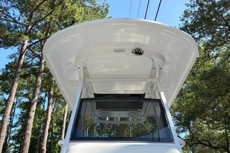 Slide: The Image of 2019 Edgewater 230CC boat canopy against a backdrop of tall trees. - 16
