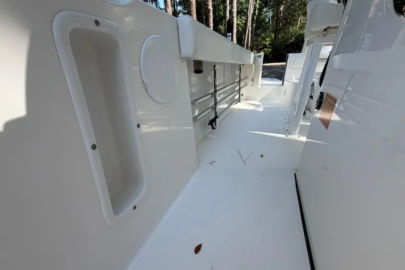Slide: The Image of Interior view of a 2019 Edgewater 230CC boat, showcasing sleek white design. - 13