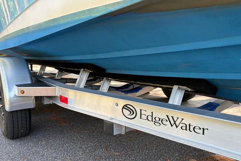 Slide: The Image of 2019 Edgewater 230CC boat on trailer, showcasing hull and brand logo. - 6