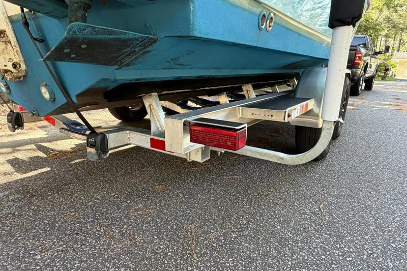 Slide: The Image of Edgewater 230CC 2019 boat on trailer, parked on asphalt road. - 7