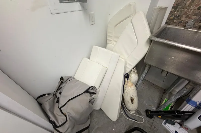 Slide: The Image of Boat cushions and accessories from a 2019 Edgewater 230CC stored in a utility room. - 31