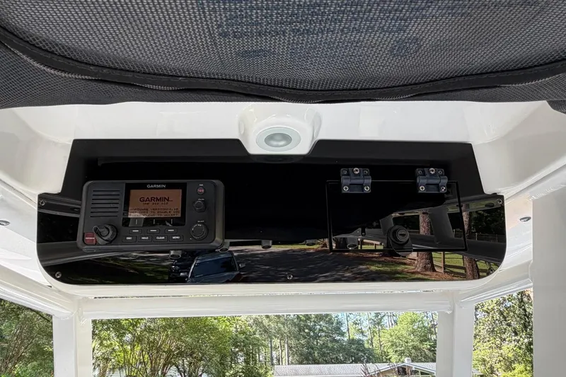 Slide: The Image of 2019 Edgewater 230CC boat console with Garmin marine radio and overhead storage. - 21