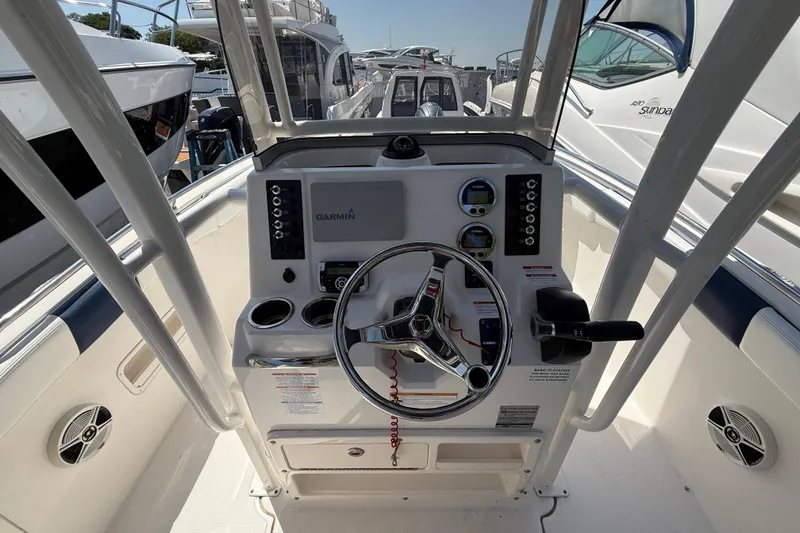Slide: The Image of 2018 Robalo R222 Explorer boat helm with Garmin navigation system and steering wheel. - 10