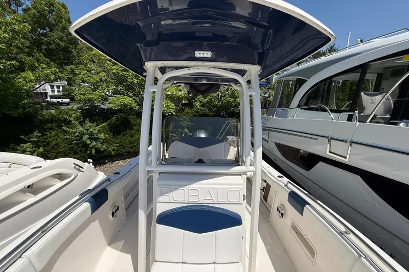 Slide: The Image of 2018 Robalo R222 Explorer boat with T-top, docked alongside other vessels. - 16