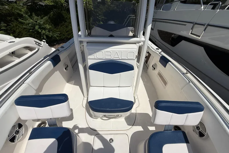 Slide: The Image of 2018 Robalo R222 Explorer boat interior with blue and white seating. - 15