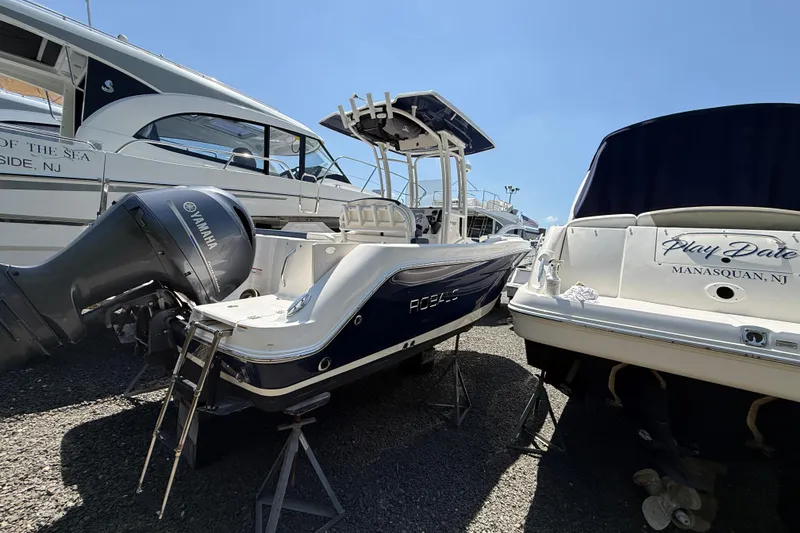 Slide: The Image of 2018 Robalo R222 Explorer boat with Yamaha engine, docked beside another vessel. - 23