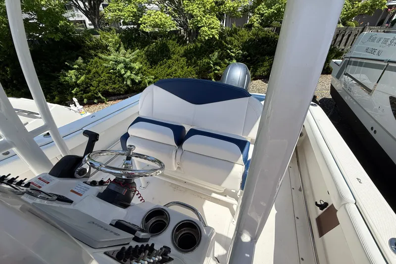 Slide: The Image of 2018 Robalo R222 Explorer boat interior with steering wheel and seating. - 11
