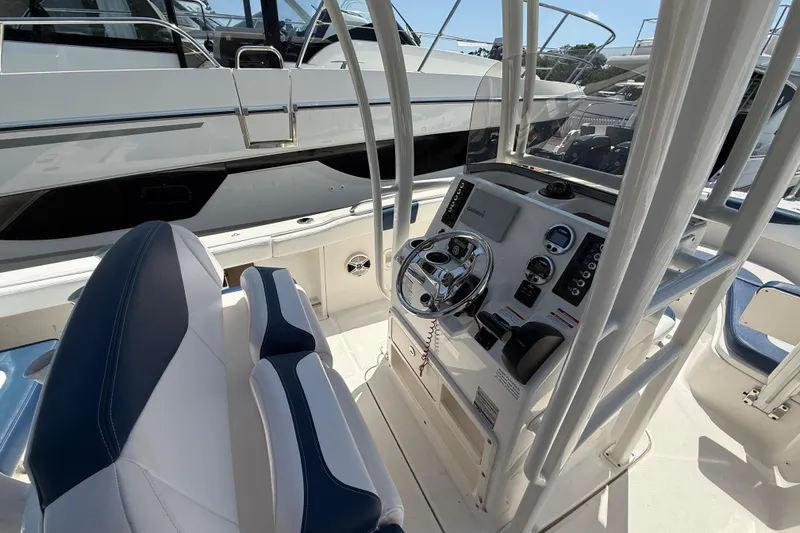Slide: The Image of 2018 Robalo R222 Explorer boat cockpit with steering wheel and control panel. - 9