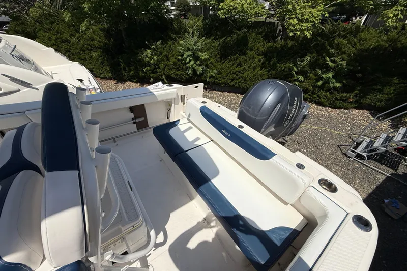 Slide: The Image of 2018 Robalo R222 Explorer boat interior with Yamaha outboard motor, featuring blue and white seating. - 19
