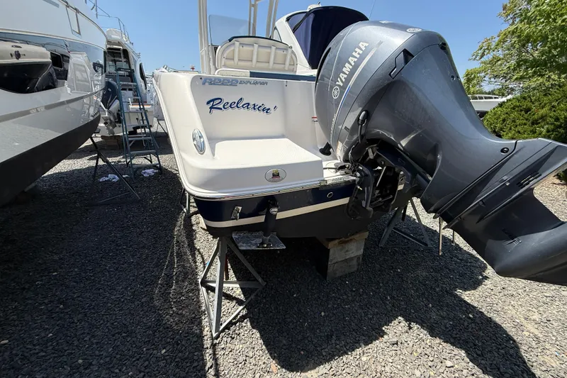 Slide: The Image of 2018 Robalo R222 Explorer boat with Yamaha engine, parked on gravel. - 21