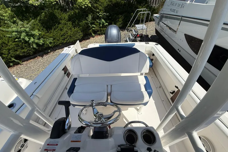 Slide: The Image of 2018 Robalo R222 Explorer boat interior with steering wheel and seating. - 12