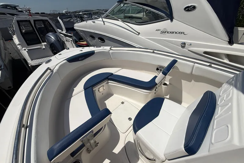 Slide: The Image of 2018 Robalo R222 Explorer boat with blue and white seating, docked among other boats. - 13