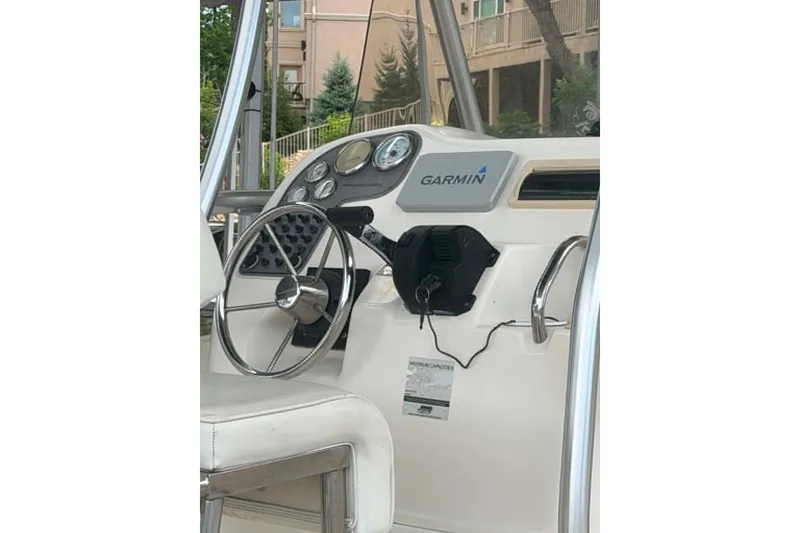 Slide: The Image of 2005 Aquasport 2100 Center Console helm with Garmin navigation system. - 5